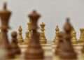 brown chess piece on white surface