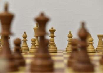 brown chess piece on white surface