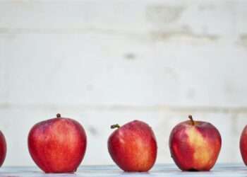 five red apples on white surface