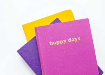 three assorted-color books