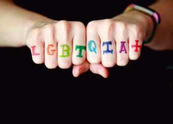 person with blue and red manicure