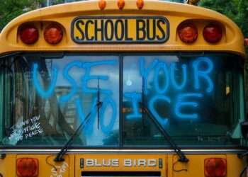 yellow school bus with green and yellow lights