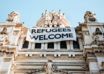 building with refugees welcome signage