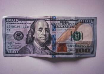 a hundred dollar bill folded into a piece of paper