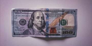 a hundred dollar bill folded into a piece of paper