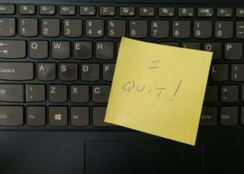 a yellow notepad on a keyboard