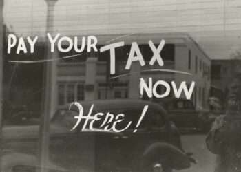 a sign that says pay your tax now here