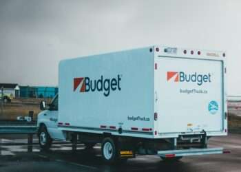 a blue and white truck parked in a parking lot